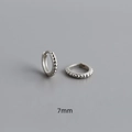 Detail of 7mm S925 sterling silver huggie earrings with a delicate beaded surface design - Inner 7mm / White Gold
