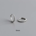 Macro shot of 9mm S925 sterling silver hoop earrings with embossed dotted texture - Inner Diameter 9mm / White Gold