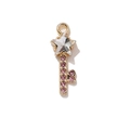 Gold-plated star-shaped key pendant featuring a large white gem and pink crystal accents - Gold Key with White Zircon
