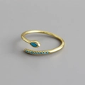 Macro shot of gold snake ring with marquise blue zircon and adjustable band detail - Adjustable Open / Turquoise Gold
