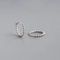 Detailed close-up of 925 sterling silver hoop earrings with a beaded textured design - 9mm / 925 Silver / White Gold