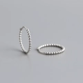 Macro shot of S925 sterling silver beaded hoop earrings with a modern textured surface - 14mm / 925 Silver / White Gold