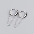 Macro shot of S925 silver hoop earrings with black zircon stones and fringe chains - 925 Silver / Black Stone Silver