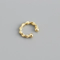 Close-up of twisted rope gold ear cuff with polished finish and spherical ends - 925 Silver / Gold