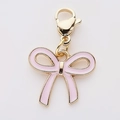 Close-up of pink enamel bow charm with gold alloy lobster clasp for DIY jewelry - Pink Bow (4)
