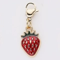 Macro detail of red enamel strawberry charm with golden lobster clasp and green leaf - Dotted Red Strawberry Style (3)