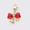 Pendentif nœud doré avec deux cristaux en forme de cœur rouge et fermoir mousqueton - Style Nœud Cœur Rouge