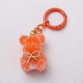 Llavero de osito naranja con textura de cristal y lazo dorado de moda actual - Naranja
