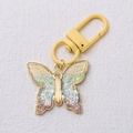 Bunter Schmetterling-Schlüsselanhänger mit gelber Schlaufe und Netzstruktur in Gold - Gelb