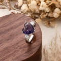 Elegant heart-shaped ring with deep purple zircon and silver band on wood stand - Heart Style / Purple