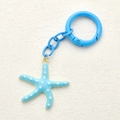 Minimalist light blue starfish keychain with white spots on textured background - Sky Blue