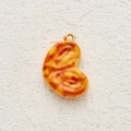 Orange bean-shaped food pendant with red spots and a gold metal ring accessory - Croissant Style (4)