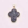 Elegant gold cross pendant with dark druzy stone center on a soft pink background - Cross