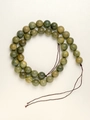 Close-up of natural green sandalwood beads showing fine wood grain and texture - 8mm Green Sandalwood 40cm