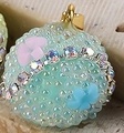 Light green round sugar bead pendant with colorful floral details and gold metal clasp - Light Green