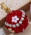 Red sugar-coated spherical pendant with pink flower and sparkling crystals - Red