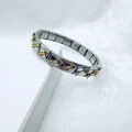 Macro shot of Italian modular charm bracelet in silver stainless steel with gold arrow detail - Silver Gold Arrow Style