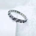 Close-up of stainless steel charm bracelet featuring a 3D teddy bear charm detail - Retro Sitting Bear Style