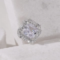Elegant square halo silver ring featuring a princess cut center stone on a white stone base - 1 (Silver)