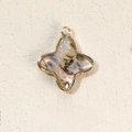 Star-shaped abalone shell pendant with gold-plated geometric metal border and hanging loop - Four-Leaf Clover