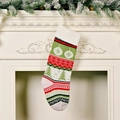 Knitted Christmas stocking with red, green and white striped patterns on a fireplace - Christmas Tree Style