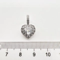 Macro detail of silver heart pendant with cubic zirconia inlay against a measuring scale - White Rhinestone Heart Pendant Only (Without Chain) / White Gold