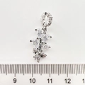 Silver flower pendant with clear cubic zirconia stones shown against a ruler for size - Leaf White Gold