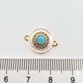 Macro detail of a round 18k gold turquoise charm with crystals and dual connectors - Full Pave Circle