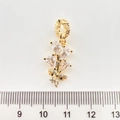 Detail of a gold-plated flower pendant with clear zircons and a ruler showing size - Leaf 18K Gold