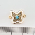 Macro view of gold-plated butterfly connector with turquoise center and shell wings - Butterfly