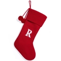 Red knitted Christmas stocking with white letter R and decorative white pom poms - Red R