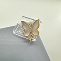 Macro shot of 18k gold plated butterfly pendant with iridescent shell wings and zircons - Earring Post White Mother of Pearl