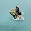Detailed view of a gold butterfly ring base with iridescent wings and a pearl mount - Ring Abalone Shell