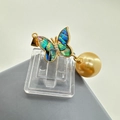 Detailed view of butterfly pendant with colorful shell inlay and hanging gold pearl - Abalone Shell Style / Pendant Abalone Shell
