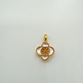 Macro shot of gold-plated four-leaf clover pendant with white mother of pearl inlay - Pendant Stand