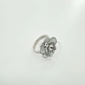 Detailopname van cameliabloem ring met ivoren bloembladen en parelzetting op witte steun - Ring Zonder Parel - Zilver