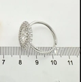Silver flower ring with white zircon stones measuring 18mm inner diameter on scale - Ring - Silver