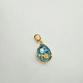 Detailed macro view of sky blue enamel pearl pendant with gold leaf motif clasp - Sky Blue Flower Leaf Teardrop Style