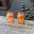 Macro view of orange resin smiling cat charms with dimensions 1.4x2.3cm for DIY crafts - Orange Cat