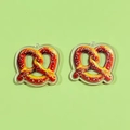 Close-up of realistic acrylic pretzel pendants with faux salt grains for DIY jewelry making - Pretzel Style (C)