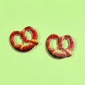 Close-up of DIY acrylic pretzel charms for earrings and necklaces with realistic salt details - Hollow Small Pretzel Style (D)