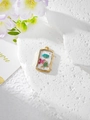 Macro detail of rectangular resin pendants with dried flowers and gold foil accents - 7 Blue Rose Red Floral