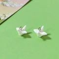 Macro view of white resin origami crane pendants with silver rings for DIY jewelry making - White Paper Crane