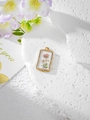 Macro shot of rectangular gold resin pendant with pink flowers and white daisies - 2 Pink White Floral