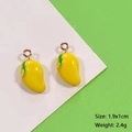 Handmade mango fruit alloy pendant in bright yellow with green leaf and gold loop - Mango