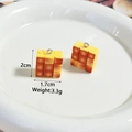 Macro detail of resin toast pendants with size labels 2cm by 1.7cm for DIY crafts - Square Toast