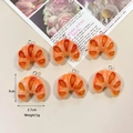 Realistic resin croissant charms for DIY jewelry making in a warm golden orange finish - Croissant