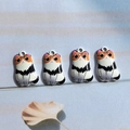 Detailed view of four cartoon calico cat alloy charms for DIY jewelry and crafts - Calico Cat / AN110