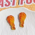 Detail view of acrylic fried chicken drumstick charms with realistic texture and DIY holes - Chicken Leg