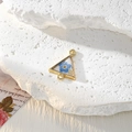 Macro shot of triangle resin flower pendant with gold frame on white textured stone - Triangle Blue Flower